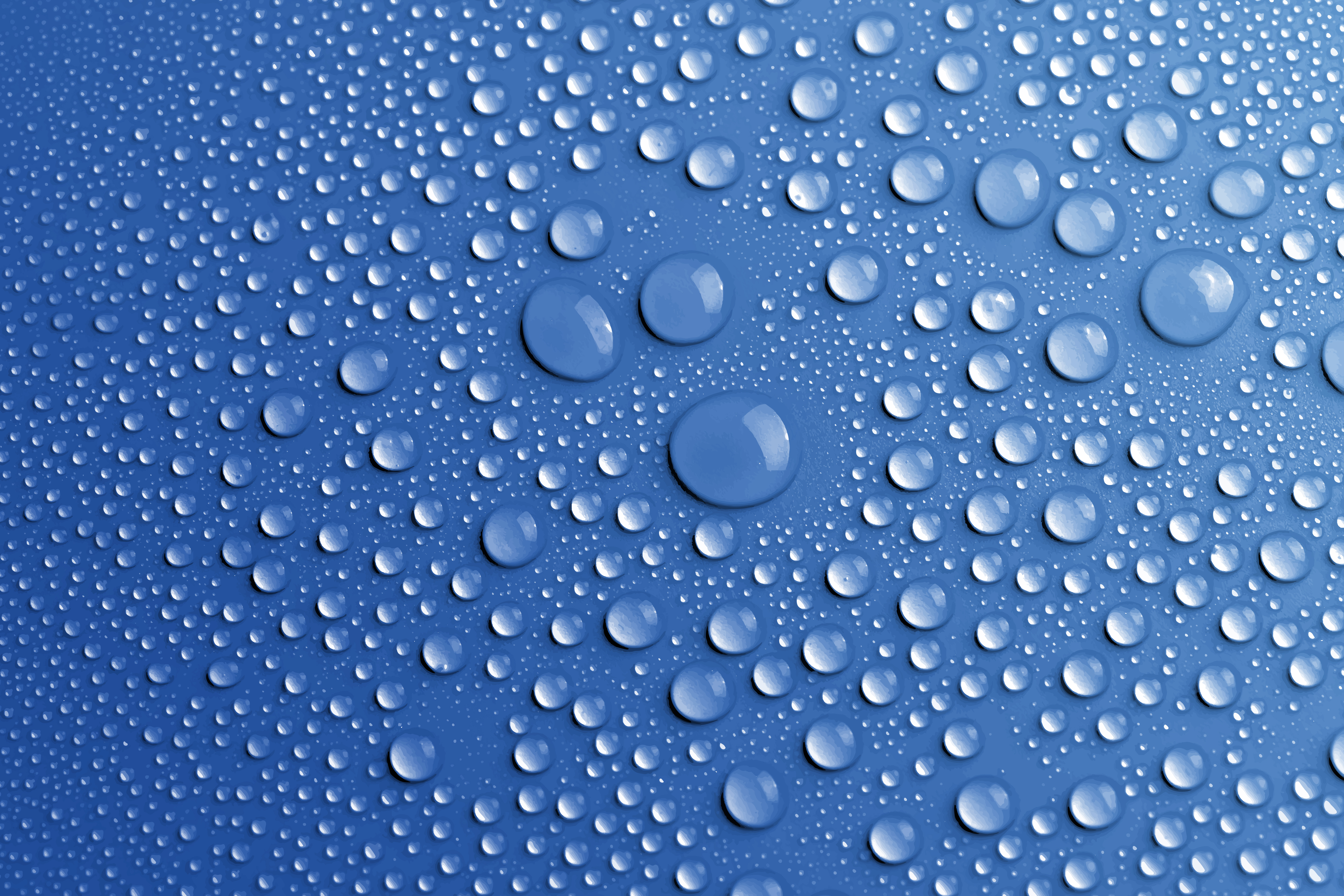 Water droplets on a dark surface, creating a refreshing and cool texture.
